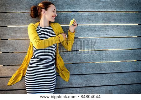 Woman with phone on sunbed