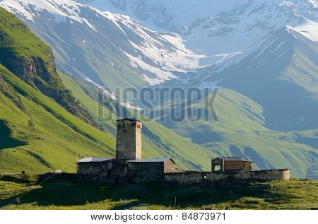 Stone medieval church in a mountain valley. View of Mount Shhara. Ushguli community, Zemo Svaneti, Georgia