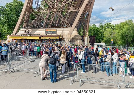 Tourists Waiting Near A Ticket Office Of The Eiffel Tower, Paris