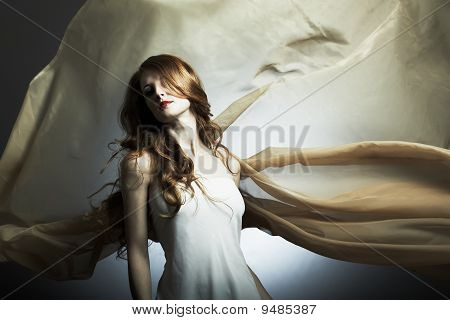 Portrait Of The Young Woman Against A Flying Fabric