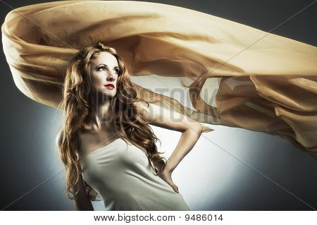 Portrait Of The Young Woman Against A Flying Fabric