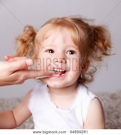 Happy Little Child Getting Her Teeth Brushed With Finger Toothbrush