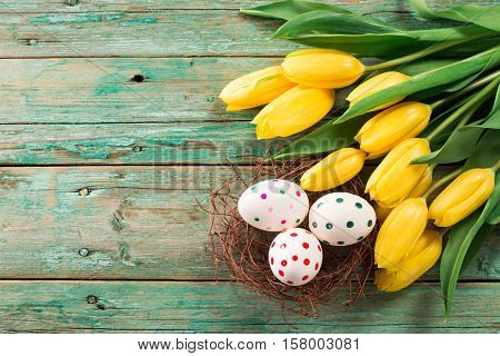 Easter Background Yellow Tulips On Wooden Table, Rabbit, Eggs,nest Candy