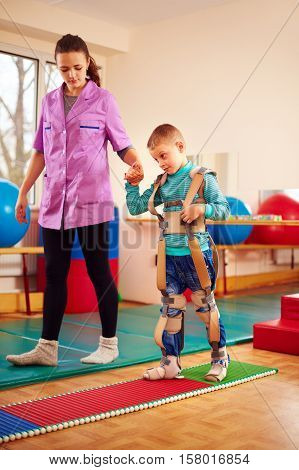 Cute Kid Having Physical Musculoskeletal Therapy In Rehabilitation Center
