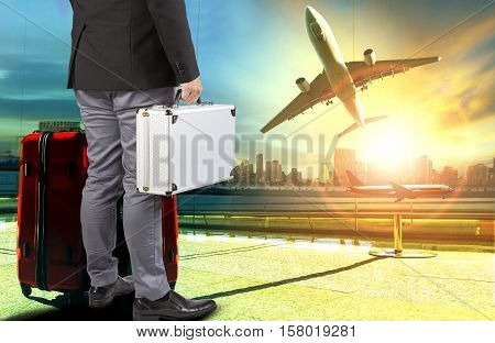 business man and breifcase traveling luggage standing in airport terminal building and passenger plane flying over sky