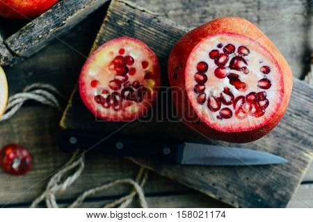 Ripe Pomegranate Fruit On Wooden Vintage Background. Red Juice P