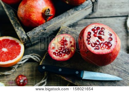 Ripe Pomegranate Fruit On Wooden Vintage Background. Red Juice P