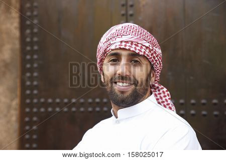 Young smiling handsome arabian man wearing traditional clothes