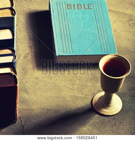 chalice of wine with bread and bible