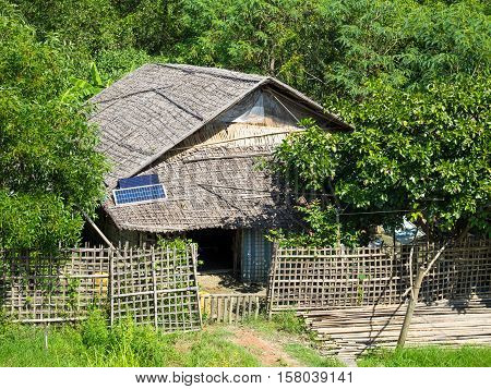 Traditional house made from straw in a village along the Kaladan River in the Rakhine State of Myanmar.