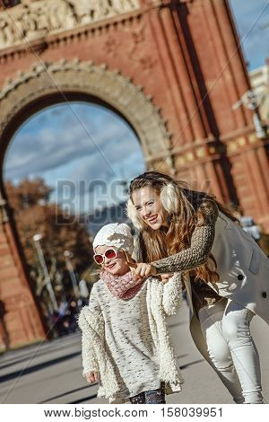 Mother Pointing On Something To Child Near Arc De Triomf