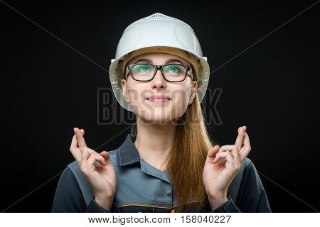 portrait of a young female worker on the black background