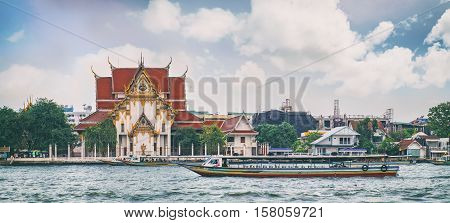 Bangkok, Thailand - January 8, 2016: Wat Rakangkositaram Woramahavihan is Buddhist Temple which located on the banks of the Chao Phraya River in the tourist center of Bangkok.