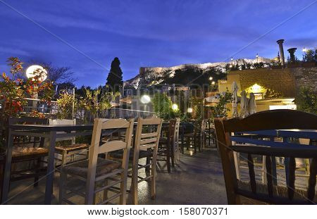PLAKA ATHENS GREECE, NOVEMBER 03 2016: traditional cafeteria on terrace Anafiotika Plaka Greece with Acropolis view. Editorial use.