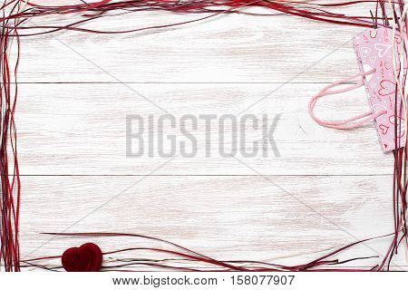 Frame for valentine's day. Top view with copy space. Photos for posts, blogs, advertising and news. White wooden background with frame. Greeting concept card valentines day