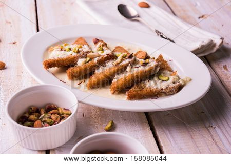 Shahi tukda prepared - deep fried bread in ghee, garnish with sweetened cream and dry fruits.