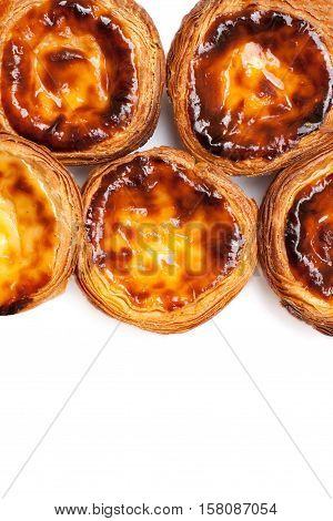 Egg Tarts isolated on white background. Heap of Typical portuguese dessert pasteis de nata close up