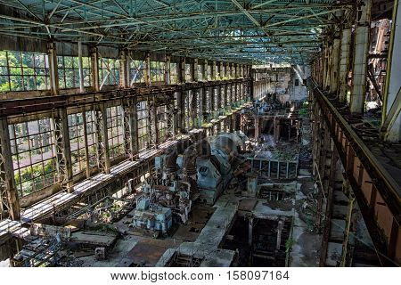 Abandoned, destroyed by war and overgrown machinery of Tkvarcheli power plant, Abkhazia, Georgia
