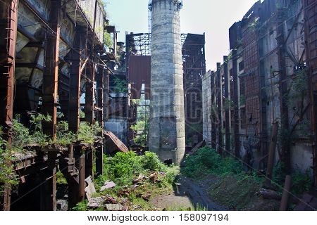 Abandoned, destroyed by war and overgrown machinery of Tkvarcheli power plant, Abkhazia, Georgia