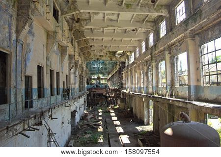 Abandoned, destroyed by war and overgrown machinery of Tkvarcheli power plant, Abkhazia, Georgia