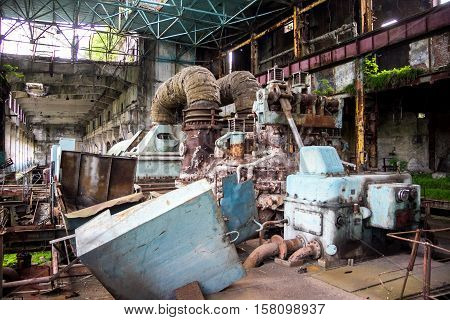 Abandoned, destroyed by war and overgrown machinery of Tkvarcheli power plant, Abkhazia, Georgia