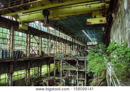 Abandoned, destroyed by war and owergrown machinery of Tkvarcheli power plant, Abkhazia, Georgia