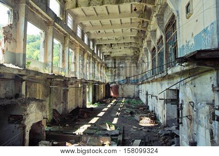 Abandoned, destroyed by war and overgrown machinery of Tkvarcheli power plant, Abkhazia, Georgia