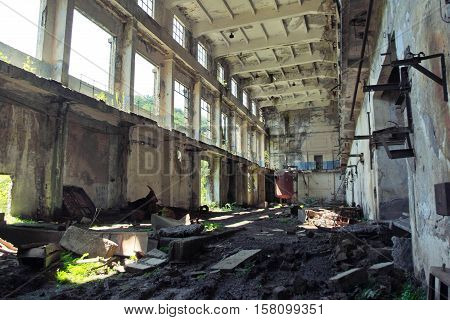 Abandoned, destroyed by war and overgrown machinery of Tkvarcheli power plant, Abkhazia, Georgia