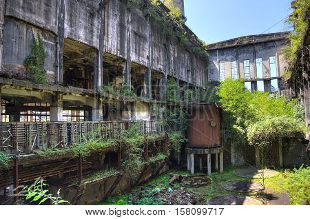 Abandoned, destroyed by war and overgrown machinery of Tkvarcheli power plant, Abkhazia, Georgia