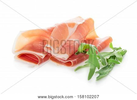 Sliced of jamon with aragula leaves isolated on white background