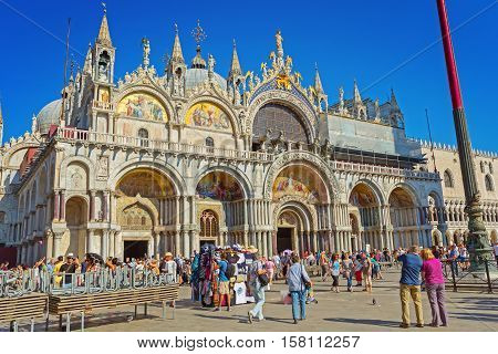 Venice Italy - September 8 2016: Patriarchal Cathedral Basilica of Saint Mark (828 1094). Piazza San Marco full of people Venice Italy.