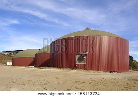 Plant of  biogas and a cow farm behind