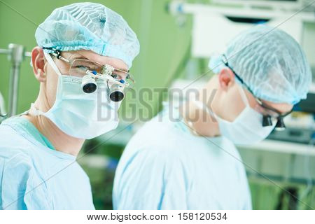 male cardiac surgeon at child cardiosurgery operating room