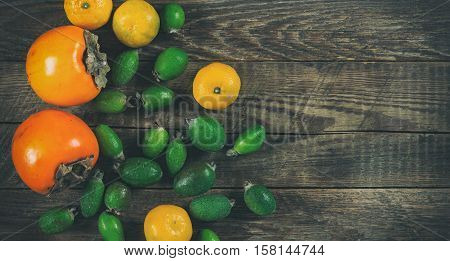 Mixed exotic fruits on wooden background. Close up