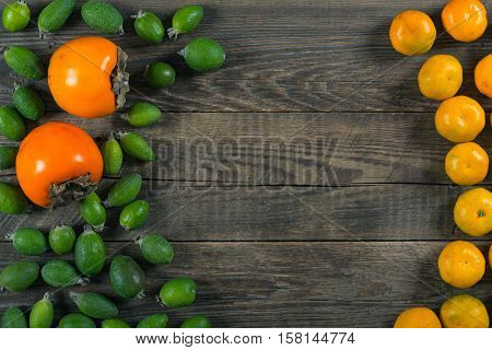 Mixed exotic fruits on wooden background. Close up