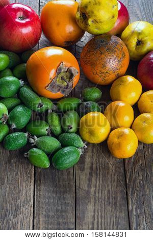 Mixed exotic fruits on wooden background. Close up