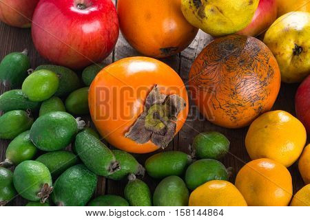 Mixed exotic fruits on wooden background. Close up