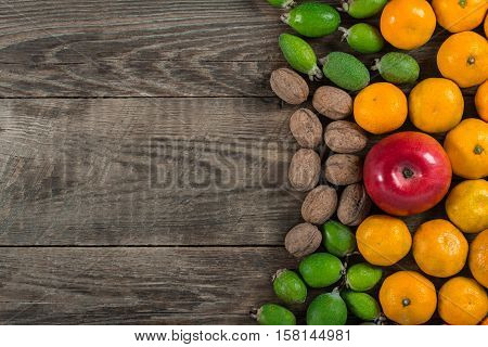 Mixed exotic fruits on wooden background. Close up