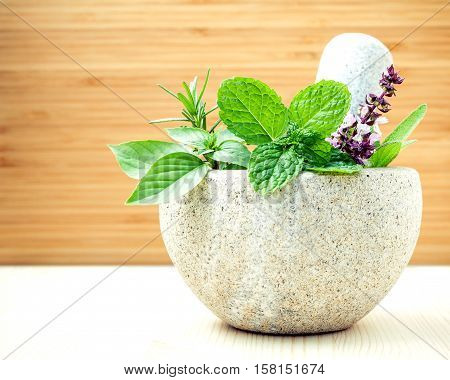 Alternative Health Care And Herbal Medicine .fresh Herbs With Mortar And Pestle On Wooden Background