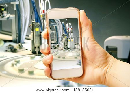 Hand holding smart phone (Mobile Phone) with centrifuge. advanced laboratory equipment
