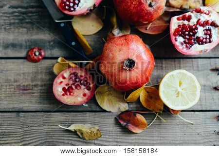 Ripe Pomegranate Fruit On Wooden Vintage Background. Red Juice P