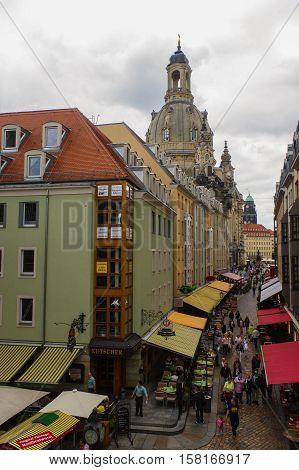 DRESDEN GERMANY - SEPTEMBER 21 2013: the Pedestrians in the Munzgasse alleyway. The historic cobblestone alley is lined with many of Dresdens most famous restaurants and cafes.