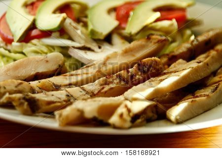 chicken fajitas with vegetables on a white plate