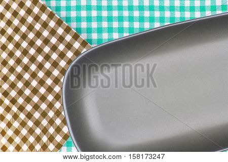 Top view plate on checkered tablecloth pattern background .Free space for products and for your text