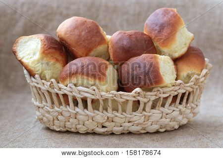 buns with cherries in wicker breadbaskets on the background from a sacking