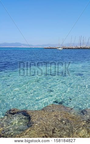Beautiful sea views with yacht and Palma de Mallorca on the horizon. L'Arenal Majorca Balearic Islands Spain.