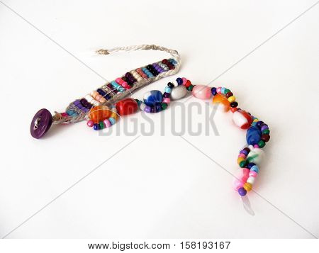Series of wristbands and bracelets made of colored beads for hand-designed websites