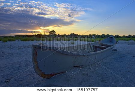 Beautiful sunset with fishing boat, close up