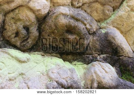 Stone altar carved into the sandstone - detail of the heads of Cherubs