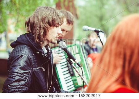 Big public market day in town. Singer and musician performing as street musician